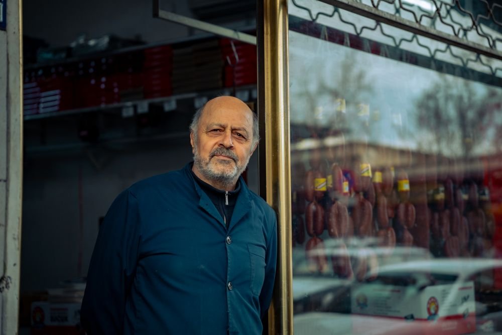 Shop owner standing at his storefront